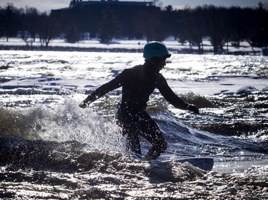 David Alicandro didn't let a little cold weather stop him from getting out for a surf Saturday December 16, 2017 on the Ottawa River.