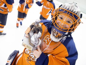 The Kanata Blazers won 2-1 in a shootout against the St. Clair Shores Saints in the Minor Atom A final on Saturday at Minto Arena. Goalie Tyler McDonald-Hoffmann shows off a big smile to go with his second-star award. Ashley Fraser/Postmedia