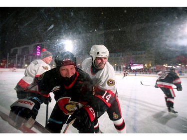 Radek Bonk (right) pins Janne Laukkanen into the boards during action and he breaks up laughing. In front of Parliament Hill, the NHL 100 Classic, featuring Ottawa Senators alumni players from 25 years, thrilled the fans in Ottawa Friday (Dec. 15, 2017) night. Julie Oliver/Postmedia