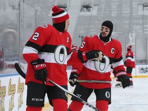 Dion Phaneuf  (L) and Erik Karlsson of the Ottawa Senators chat during morning practice on the outdoor rink at TD Place, December 10, 2017.