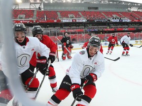 Jean-Gabriel Pageau (L), Erik Karlsson  and Gabriel Dumont (R)  of the Ottawa Senators during morning practice on the outdoor rink at TD Place, December 10, 2017.