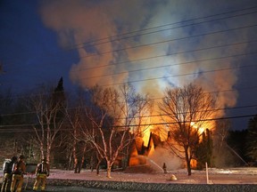 Flames shoot into the evening sky while a church on Slack Road burns.