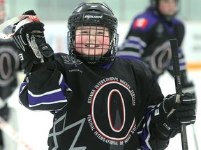 Clementine Burgess of the Yukon peewee team was all smiles after Friday's game against Alberta. She was named winner of the hardest-working player award.  Julie Oliver/Postmedia