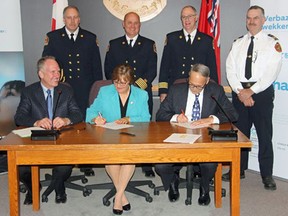 Canadian Nuclear Laboratories (CNL) and the Town of Deep River signed an interim fire services agreement that will see CNL's Chalk River Laboratories (CRL) Fire Operations support the town's fire department from Dec. 4 to June 30, 2018. Pictured in back (from left) are CRL Fire Operations deputy fire chief Gerry Johnston, CRL Fire Operations fire chief Gary McRae, CRL Fire Operations deputy fire chief Gary Pardy and Deep River Fire Department deputy fire chief Robert Labre. Pictured in front (from left) are AECL President and CEO Richard Sexton, Deep River Mayor Joan Lougheed and CNL President and CEO Mark Lesinkski.
