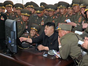 This undated file picture released from North Korea's official Korean Central News Agency (KCNA) on April 27, 2014 shows North Korean leader Kim Jong-Un (C) looking at a computer as he inspects a shelling drill of a long-range artillery sub-unit tasked to hit major targets in the southwestern waters at undisclosed place in North Korea. AFP/Getty Images