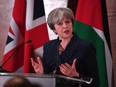 British Prime Minister Theresa May addresses guests and media during a speech at the Jordan museum on November 30, 2017 in Amman, Jordan. She's been involved in a public spat this week with President Donald Trump.