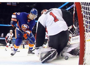 Anders Lee of the Islanders gets the puck past Senators goalie Mike Condon, but it rolls wide of the net, allowing Ottawa to hold on for victory on Friday night.