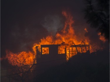SUNLAND, CA - DECEMBER 05: A house burns during the Creek Fire on December 5, 2017 in Sunland, California. Strong Santa Ana winds are rapidly pushing multiple wildfires across the region, expanding across tens of thousands of acres and destroying hundreds of homes and structures.