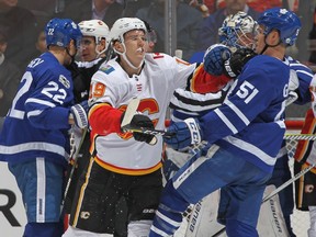 Matthew Tkachuk of the Calgary Flames battles against Jake Gardiner of the Toronto Maple Leafs during a game on December 6, 2017 in Toronto.