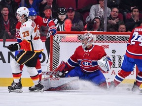 Sean Monahan #23 of the Calgary Flames scores an overtime goal against Carey Price #31 of the Montreal Canadiens during the NHL game at the Bell Centre on December 7, 2017 in Montreal, Quebec, Canada.  The Calgary Flames defeated the Montreal Canadiens 3-2 in overtime.