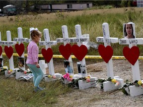 Shaelyn Gisler,4, prepares to leave flowers on crosses named for the victims outside the First Baptist Church, which was the scene of the mass shooting that killed 26 people in Sutherland Springs, Texas on Nov. 9, 2017.