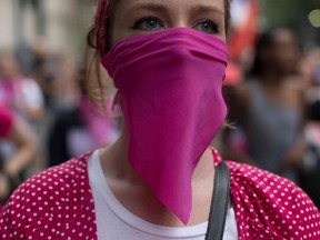 Women wear pink masks protesting the violence against women in Rio de Janeiro, Brazil.