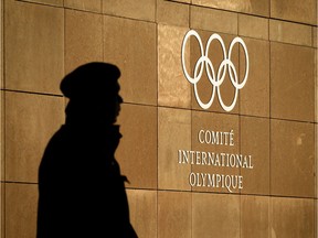 A private guard is seen in silhouette in front of the International Olympic Committee (IOC) at their headquarters prior to an executive meeting on December 5, 2017 in Pully near Lausanne. The International Olympic Committee meets to decide whether to bar Russia from the 2018 Winter Olympics for doping violations, in one of the weightiest decisions ever faced by the Olympic movement.