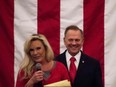 Republican Senatorial candidate Roy Moore smiles as his wife Kayla speaks at a rally in Midland, Alabama, on December 11, 2017.