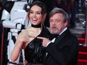 British actress Daisy Ridley (L) and US actor Mark Hamill (R) pose on the red carpet for the European Premiere of Star Wars: The Last Jedi at the Royal Albert Hall in London on December 12, 2017.
