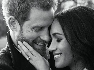 A handout picture released on December 21, 2017 by Kensington Palace shows Britain's Prince Harry posing with his fiance Meghan Markle at Frogmore House in Windsor in one of two official engagement photos.