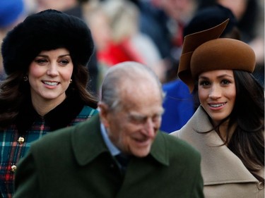 (L-R) Britain's Catherine, Duchess of Cambridge, Britain's Prince Philip, Duke of Edinburgh and US actress and fiancee of Britain's Prince Harry Meghan Markle (R) arrive to attend the Royal Family's traditional Christmas Day church service at St Mary Magdalene Church in Sandringham, Norfolk, eastern England, on December 25, 2017.