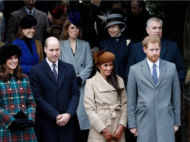 Britain's Catherine, Duchess of Cambridge, (L) and Britain's Prince William, Duke of Cambridge, (2L), US actress and fiancee of Britain's Prince Harry Meghan Markle (2R) and Britain's Prince Harry (R) stand together in front of other members of the family as they wait to see off Britain's Queen Elizabeth II after attending the Royal Family's traditional Christmas Day church service at St Mary Magdalene Church in Sandringham, Norfolk, eastern England, on December 25, 2017.