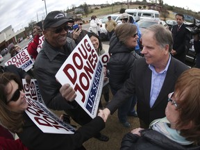 Democratic candidate for U.S. Senate Doug Jones greets supporters and voters outside Bethal Baptist Church Tuesday, Dec. 12, 2017, in Birmingham , Ala. Jones is facing Republican Roy Moore.