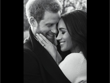 A handout picture released on December 21, 2017 by Kensington Palace shows Britain's Prince Harry posing with his fiance Meghan Markle at Frogmore House in Windsor.
