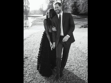 A handout picture released on December 21, 2017 by Kensington Palace shows Britain's Prince Harry posing with his fiance Meghan Markle at Frogmore House in Windsor.