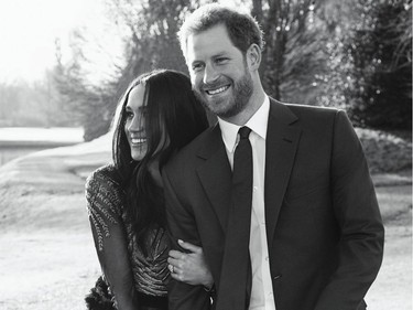 A handout picture released on December 21, 2017 by Kensington Palace shows Britain's Prince Harry posing with his fiance Meghan Markle at Frogmore House in Windsor.