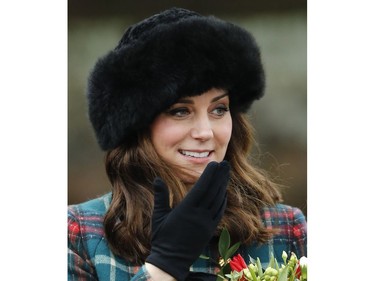 Kate Duchess of Cambridge smile as she holds a bunch of flowers received from well wishers following the traditional Christmas Day church service, at St. Mary Magdalene Church in Sandringham, England, Monday, Dec. 25, 2017.