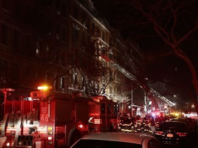 Firefighters respond to a building fire Thursday, Dec. 28, 2017, in the Bronx borough of New York. The Fire Department of New York says a blaze raging in a Bronx apartment building has seriously injured more than a dozen of people.