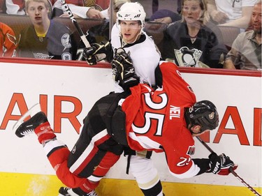 Ottawa Senators' Chris Neil hits Pittsburgh Penguins' Sidney Crosby during first period action at Scotiabank Place in Ottawa, April 20, 2010.