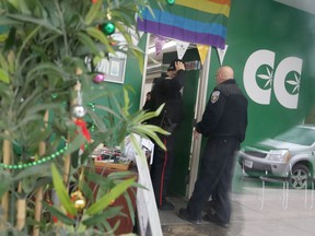Police join a bailiff serving an eviction notice at Cannabis Culture's Bank Street dispensary.