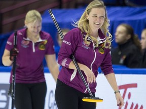 Skip Chelsea Carey smiles as she passes lead Laine Peters during the final end of play against Team Flaxey on Dec. 5, 2017