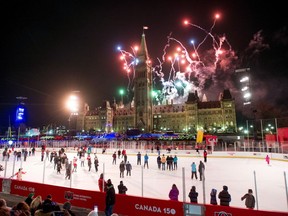 Fireworks explode above Centre Block's Peace Tower as skaters look on from the Canada 150 ice rink during the illumination launch ceremony of Christmas Lights Across Canada on Parliament Hill in Ottawa on Thursday, Dec. 7, 2017.