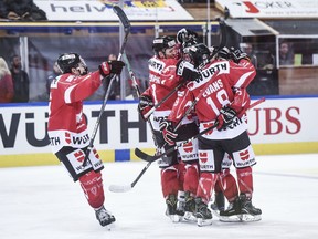 Canada's team celebrates after scoring 2:0 during the final game between Team Canada and Team Suisse at the 91st Spengler Cup ice hockey tournament in Davos, Switzerland, Sunday, Dec. 31, 2017.