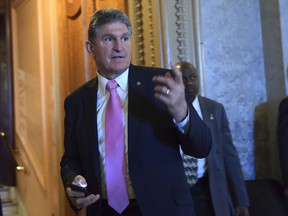 Sen. Joe Manchin, D-W.Va., walks on Capitol Hill in Washington, Friday, Dec. 1, 2017.