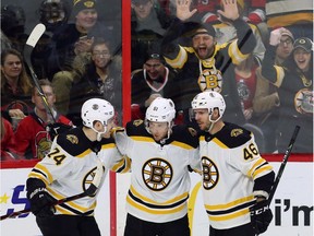 Bruins forward Ryan Spooner (51) celebrates his second goal of the night with teammates David Krejci (46) and Jake DeBrusk (74) during the second period.