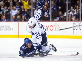 Toronto's Auston Matthews (34) and Vancouver's Brock Boeser collide during the third period of Saturday's game.