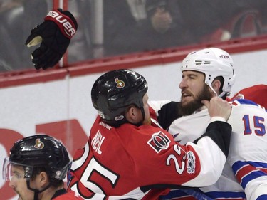 Ottawa Senators right wing Chris Neil (25) drops the gloves and throws a punch at New York Rangers left wing Tanner Glass (15) as Senators goalie Craig Anderson (41) looks on during the second period in game five of a second-round NHL hockey Stanley Cup playoff series in Ottawa on Saturday, May 6, 2017.