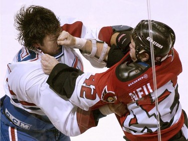 Ottawa Senators rightwinger Chris Neil battles Montreal Canadiens Stephane Quintal during second period action September 30, 2001 in Montreal.