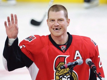 Ottawa Senators' Chris Neil salutes the crowd during a ceremony to mark his 1,000th NHL game prior to NHL action against the San Jose Sharks on Wednesday, December 14, 2016 in Ottawa.