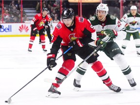 Senators winger Bobby Ryan moves the puck past Wild defenceman Jonas Brodin during a game in Ottawa on Dec. 19.