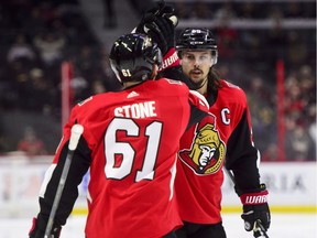 Ottawa Senators' Erik Karlsson celebrates a goal with teammate Mark Stone as they take on the Minnesota Wild during second period NHL hockey action in Ottawa on Tuesday, Dec. 19, 2017.