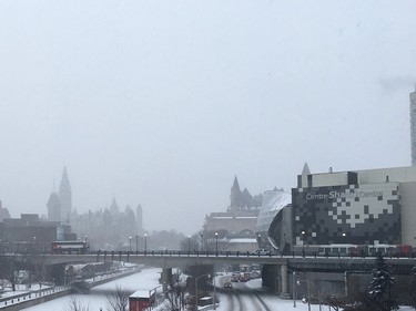 The Peace Tower and other downtown Ottawa landmarks were shrouded in grey Tuesday morning after winter’s first substantial snowfall.