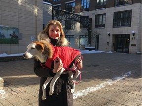 Isabel Scheier bundled her dog Daisy in a warm Canada Pooch coat before their morning walk. Photo by Jennifer Liu/Postmedia