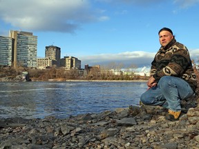 Jason Arbour is an Indigenous man of mixed Mohawk and Algonquin descent who says the Mohawk have a strong claim to the islands in the Ottawa River where the Zibi development is being planned.  He is photographed on Victoria Island, with the site of his ancestors' reserve behind him.