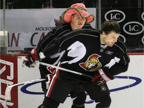 October 31, 2007 - Sens "Juice Boy" RW #25 Chris Neil distracts #16 Brian McGrattan as he shoots during the Sens post-practice shooting competition. Ottawa Senators practice this morning at Scotiabank Place in preparation for their game Thursday against the Atlanta Thrashers.