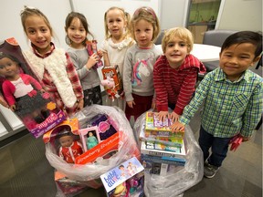 The kids from Mutchmor Public School have spent the last little while collecting a little over 500 toys, games, clothing and assorted other gifts to donate to charity. (from left) Gisele Allam, 6, Ella Barry, 6, Brielle Loschman, 5, Adeline Giles, 5, Henry Morris, 4, Xavier Aumeerally, 5, have a quick look at some of the toys before they gathered for an assembly to celebrate the effort. Photo Wayne Cuddington/ Postmedia