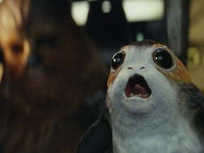 This image released by Lucasfilm shows Chewbacca, left, and a Porg in a scene from "Star Wars: The Last Jedi." (Lucasfilm via AP)