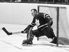 Toronto Maple Leafs' Johnny Bower makes a kick save during a playoff action against The Montreal Canadiens in Montreal in 1966. Canadian hockey legend Johnny Bower has died. A statement from his family says the 93-year-old died after a short battle with pneumonia.