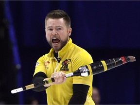Mike McEwen of Winnipeg pumps his fist after making a key shot in the ninth end of Saturday night's semifinal against Brad Gushue of St. John's.