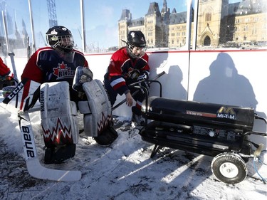 The 19th annual Bell Capital Cup officially got underway at the Canada 150 hockey rink on Parliament Hill in Ottawa Wednesday Dec 27, 2017. The Brampton Canadettes (white and blue) and the Kanata Rangers girls Pee-Wee AA made it through the first period of the 10:10 a.m. game Wednesday before it was called off due to poor ice conditions as a result from the weather being too cold. Two Kanata Rangers warm their hands up during Wednesday's game.    Tony Caldwell